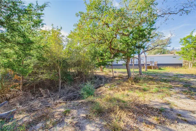 a view of a yard with swimming pool
