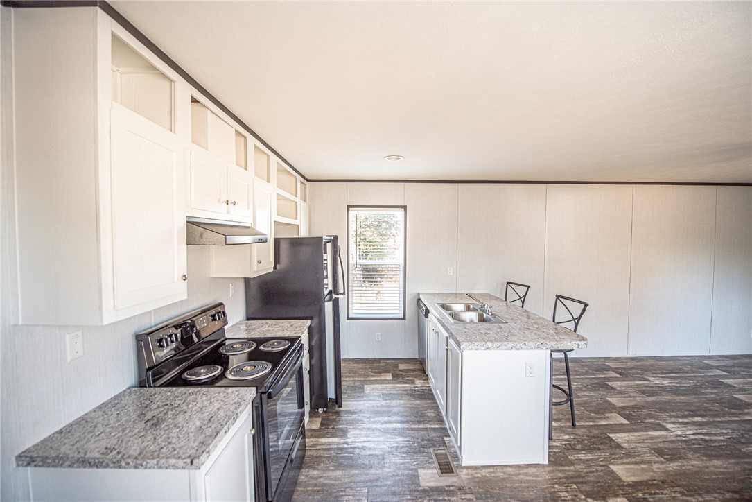 551 Boysenberry Road Somerville, TX 77879 - Photo 6 of 38 a kitchen with stainless steel appliances granite countertop a sink stove and refrigerator