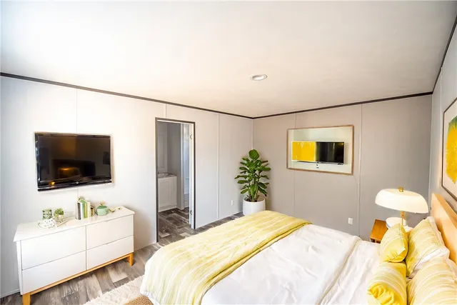 a bedroom with a bed and a flat screen tv