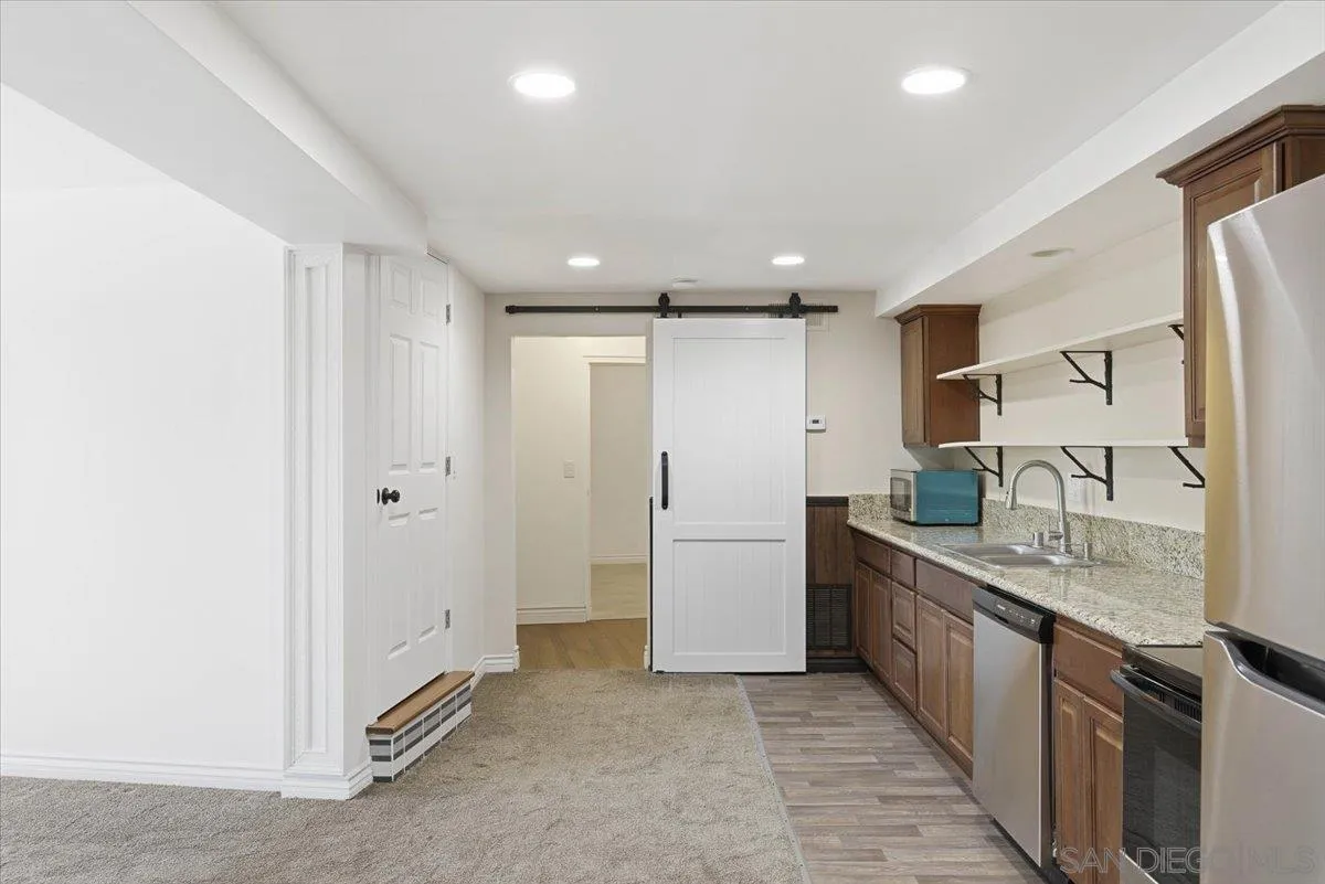 4341 Vista Way, Unit A La Mesa, CA 91941 - Photo 12 of 24 a large kitchen with stainless steel appliances granite countertop a lot of counter space and a sink
