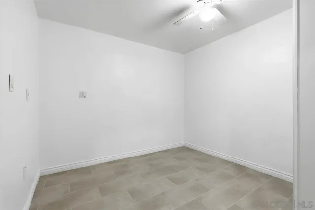 an empty room with a fan