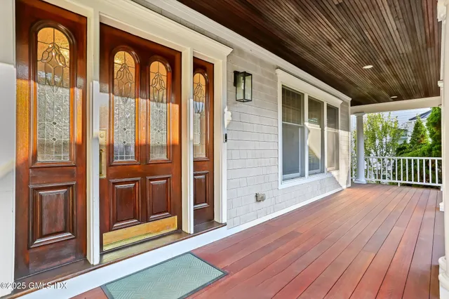a view of porch with a door and wooden floor
