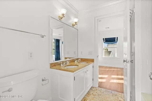 a view of an empty room with wooden floor and cabinets