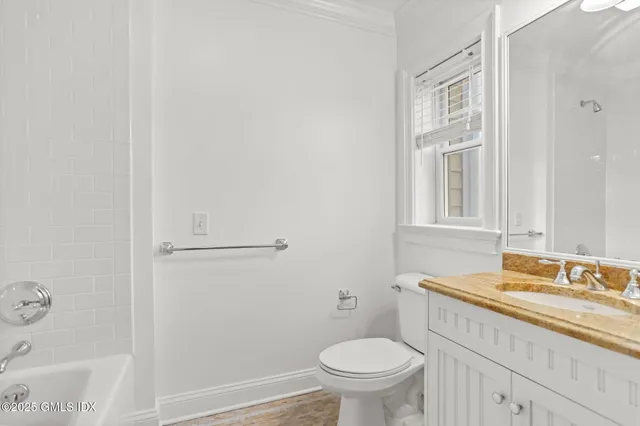 an empty room with furniture and a fireplace