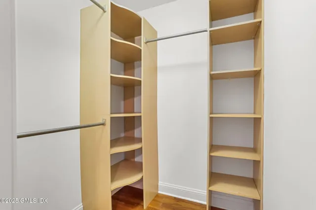 a view of empty room with kitchen