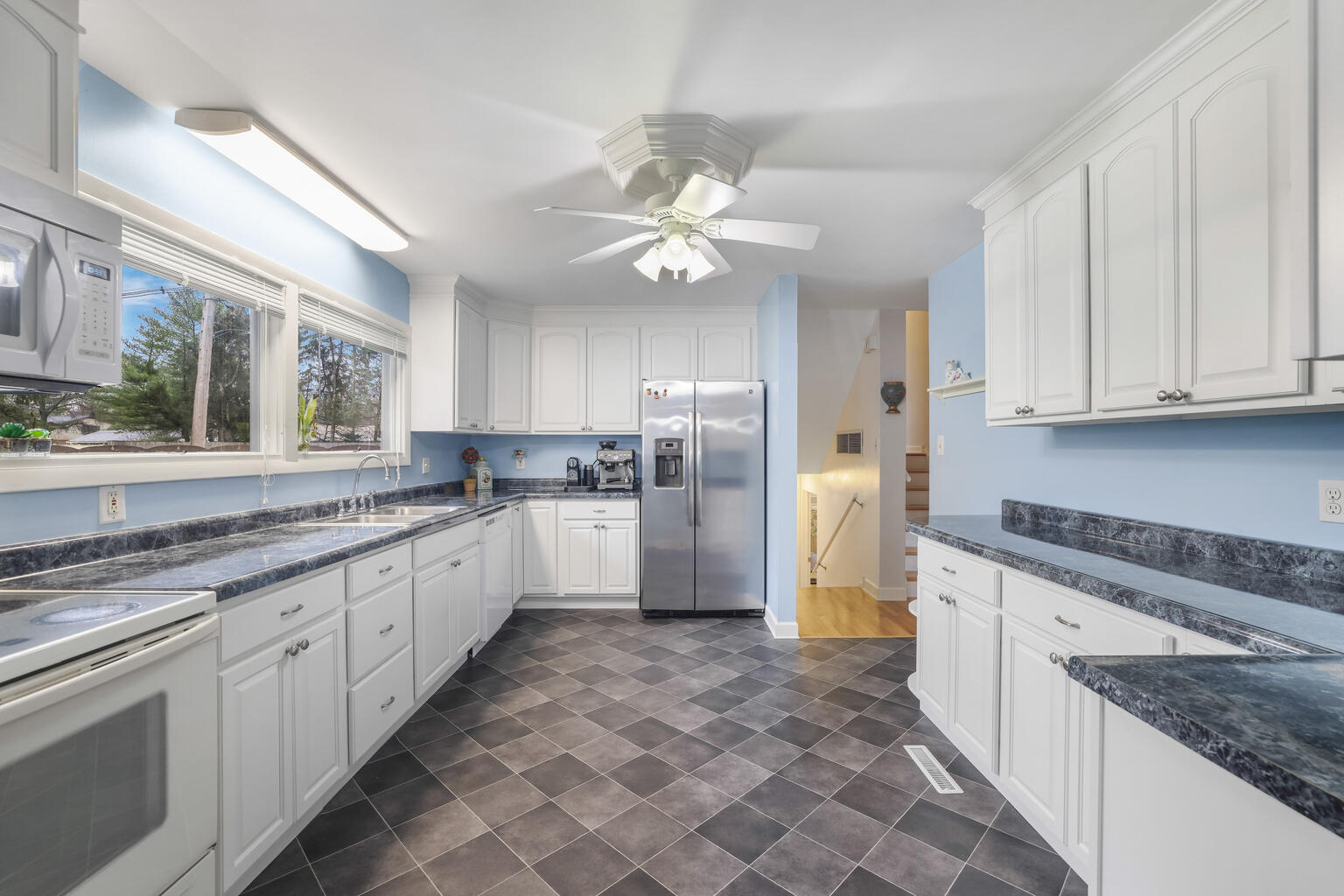 1508 Mayfair Road Champaign, IL 61821 - Photo 13 of 41 a kitchen with appliances cabinets a sink and a counter top space