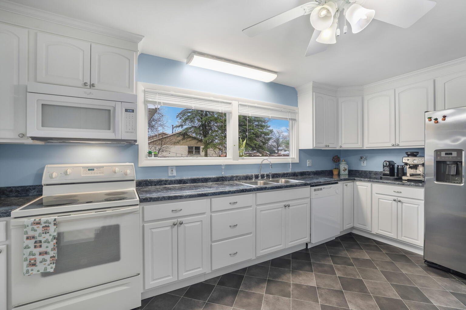 1508 Mayfair Road Champaign, IL 61821 - Photo 14 of 41 a kitchen with stainless steel appliances granite countertop white cabinets a sink and dishwasher