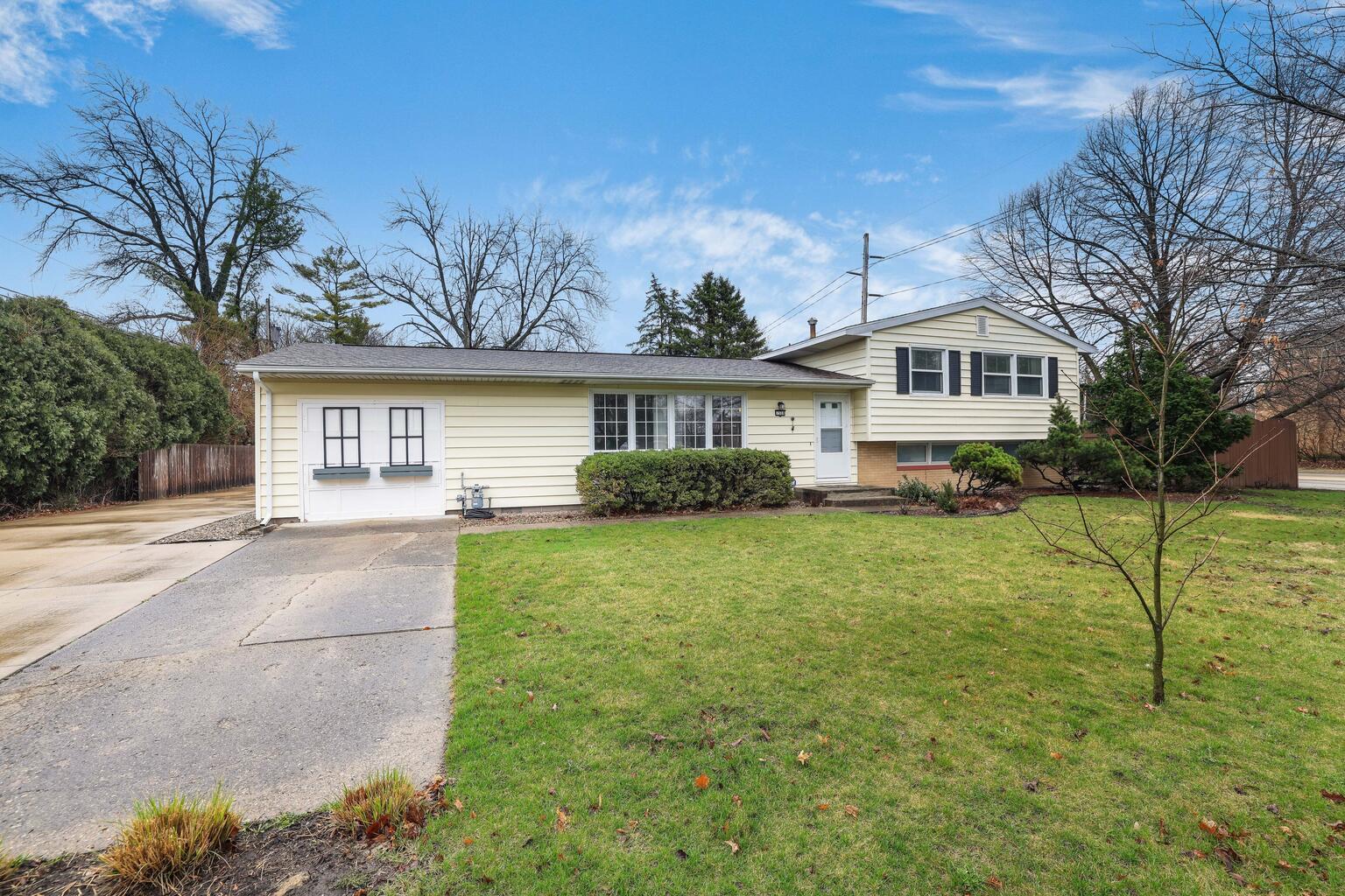 1508 Mayfair Road Champaign, IL 61821 - Photo 2 of 41 a front view of a house with a yard and trees