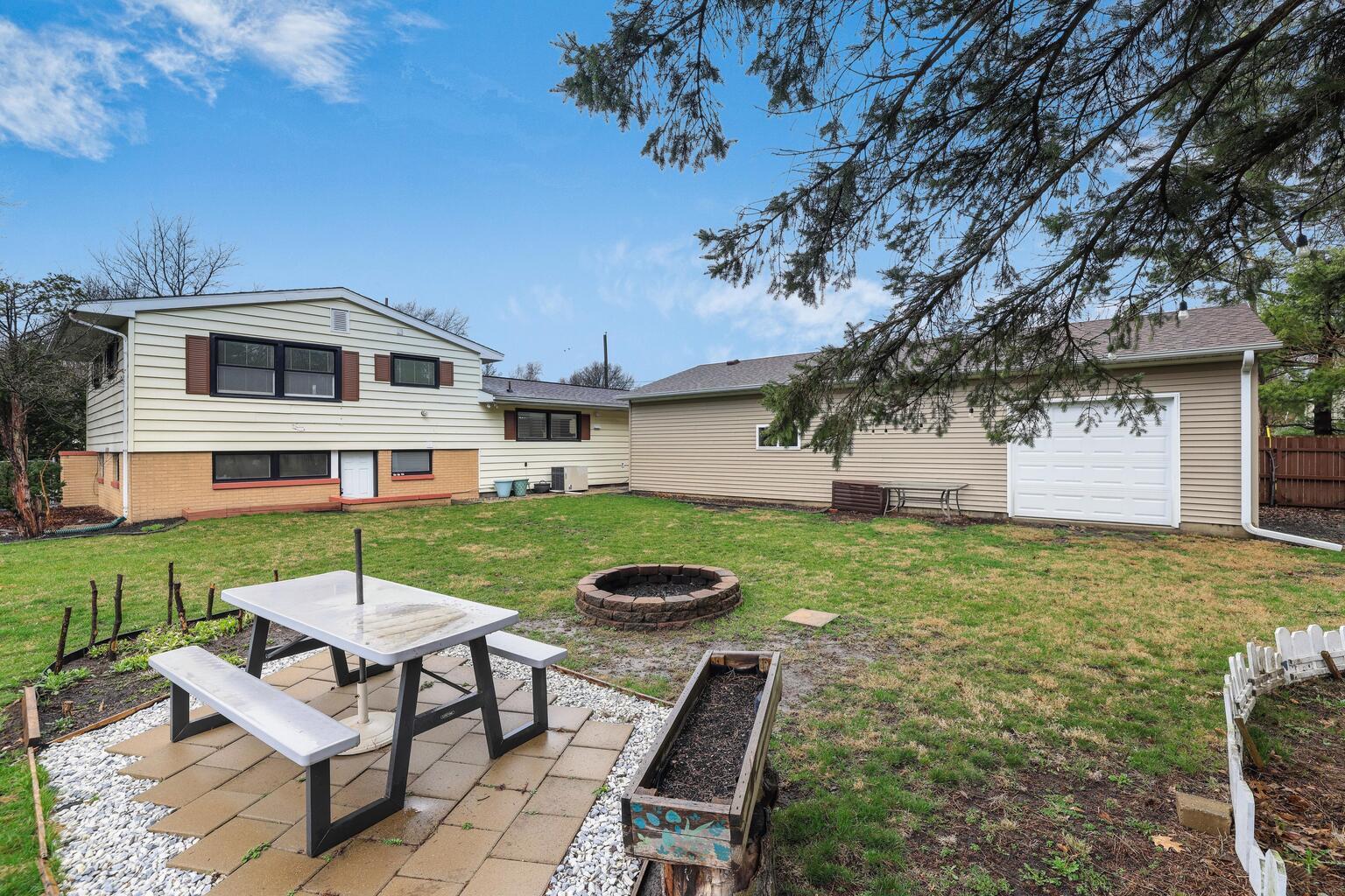 1508 Mayfair Road Champaign, IL 61821 - Photo 38 of 41 a view of a white house with a yard table and chairs