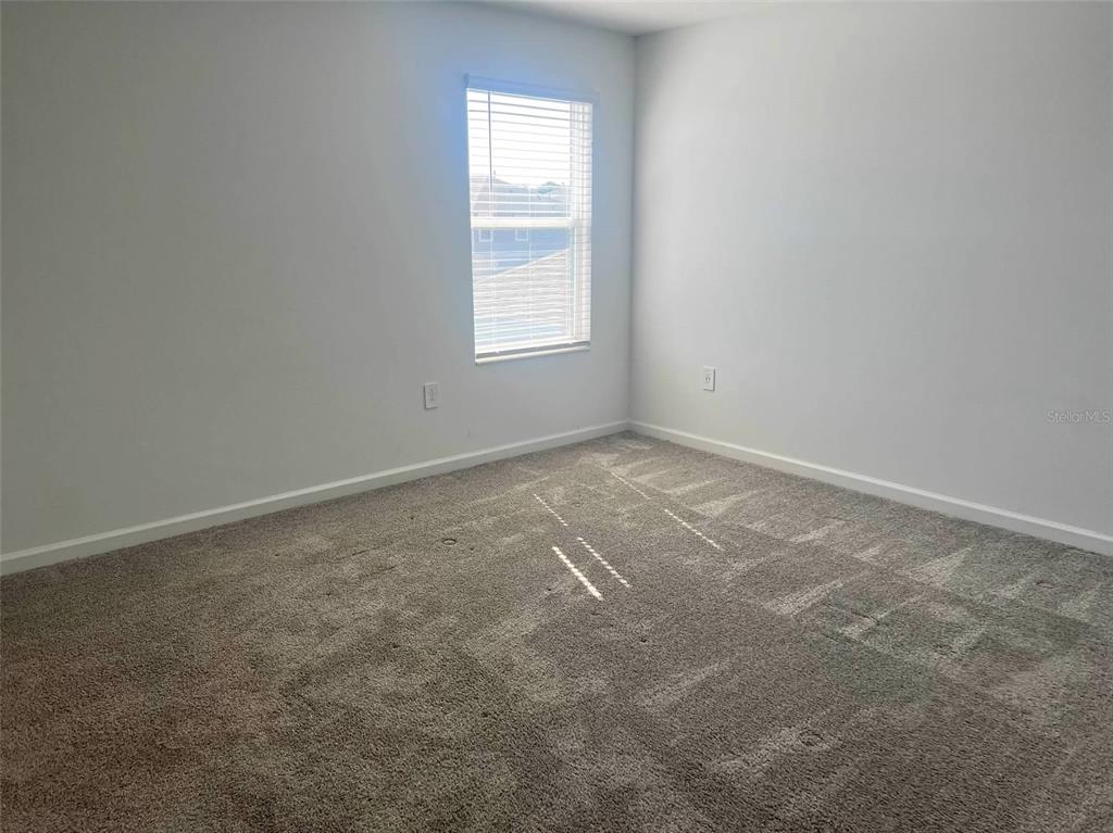 5554 Braken Fern Way Leesburg, FL 34748 - Photo 11 of 16 an empty room with windows