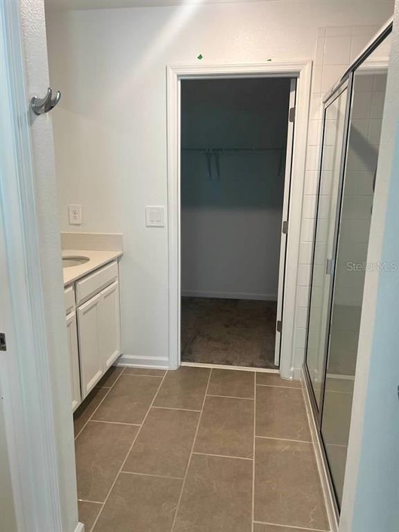 5554 Braken Fern Way Leesburg, FL 34748 - Photo 12 of 16 a bathroom with a shower and a sink