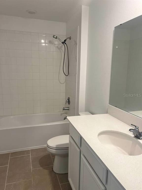 5554 Braken Fern Way Leesburg, FL 34748 - Photo 14 of 16 a bathroom with a sink a toilet and shower