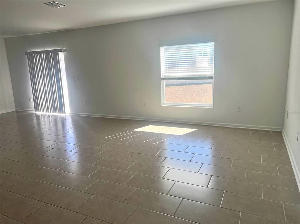 5554 Braken Fern Way Leesburg, FL 34748 - Photo 5 of 16 a view of an empty room with a window