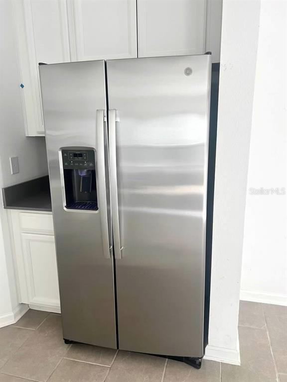5554 Braken Fern Way Leesburg, FL 34748 - Photo 9 of 16 a kitchen with metallic refrigerator freezer and a dishwasher