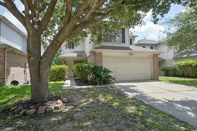 a view of a house with a tree in front