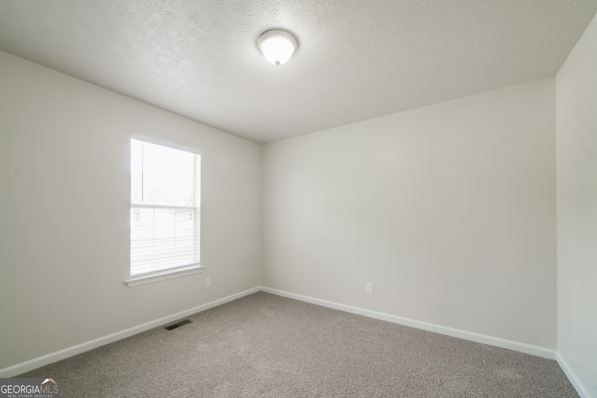 322 Yale Court Villa Rica, GA 30180 - Photo 12 of 17 an empty room with a window