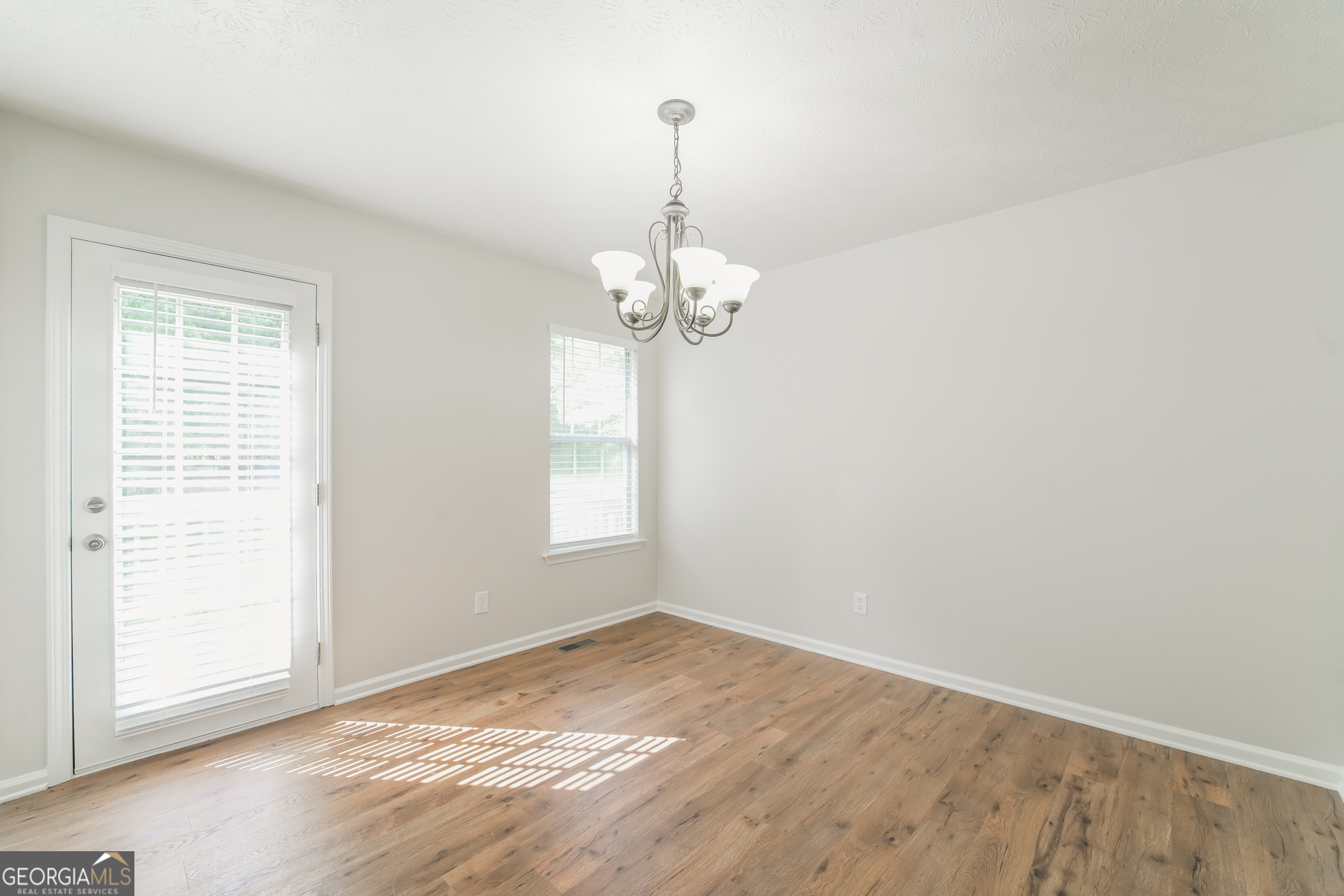 322 Yale Court Villa Rica, GA 30180 - Photo 5 of 17 an empty room with wooden floor and windows