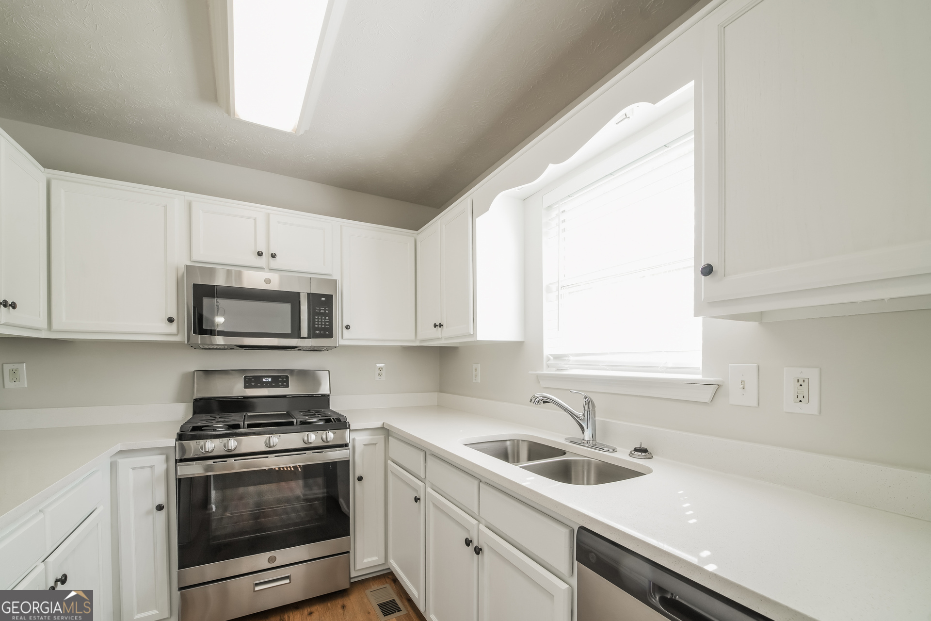 322 Yale Court Villa Rica, GA 30180 - Photo 6 of 17 a kitchen with granite countertop a sink a stove and cabinets