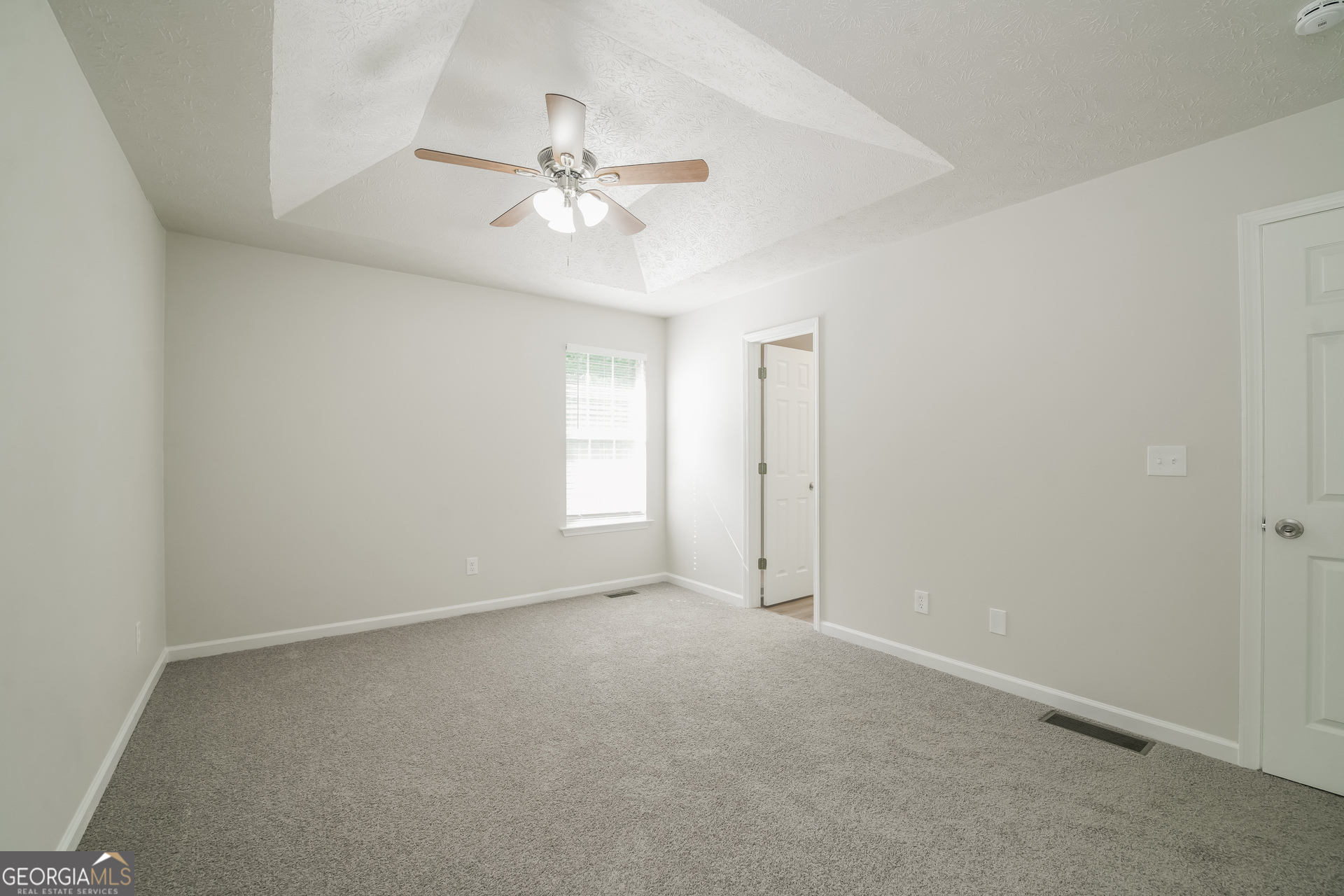 322 Yale Court Villa Rica, GA 30180 - Photo 8 of 17 an empty room with windows and fan