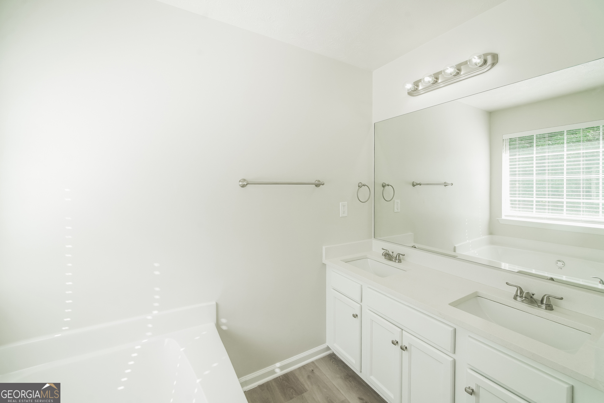 322 Yale Court Villa Rica, GA 30180 - Photo 10 of 17 a bathroom with a sink a mirror and a bathtub