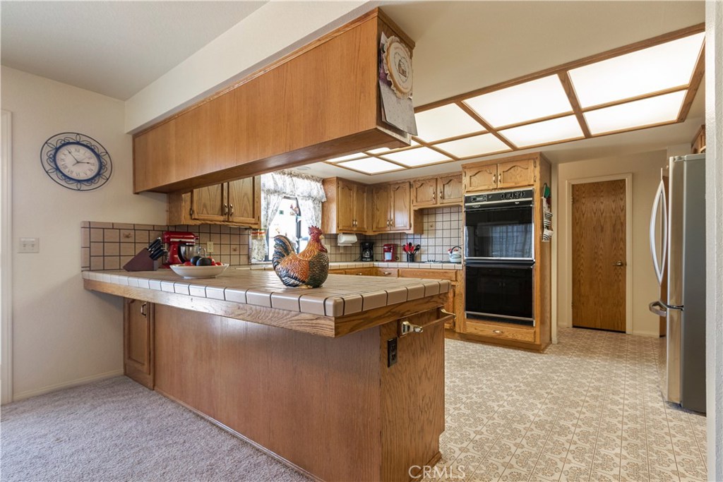 1775 Southfork Place Paso Robles, CA 93446 - Photo 17 of 36 a kitchen with stainless steel appliances granite countertop a sink and a refrigerator