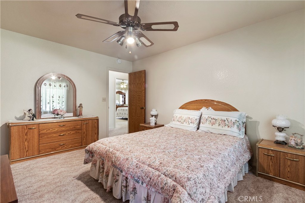 1775 Southfork Place Paso Robles, CA 93446 - Photo 21 of 36 a bedroom with a large bed and a chandelier