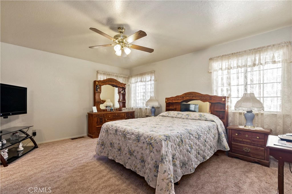 1775 Southfork Place Paso Robles, CA 93446 - Photo 25 of 36 a bedroom with a bed and a chandelier