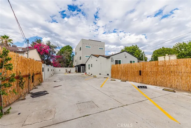 a view of a white house with a yard