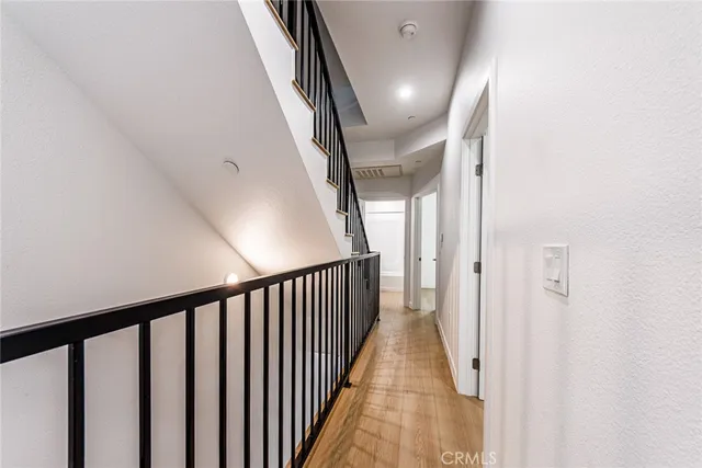 a view of staircase with railing and white walls