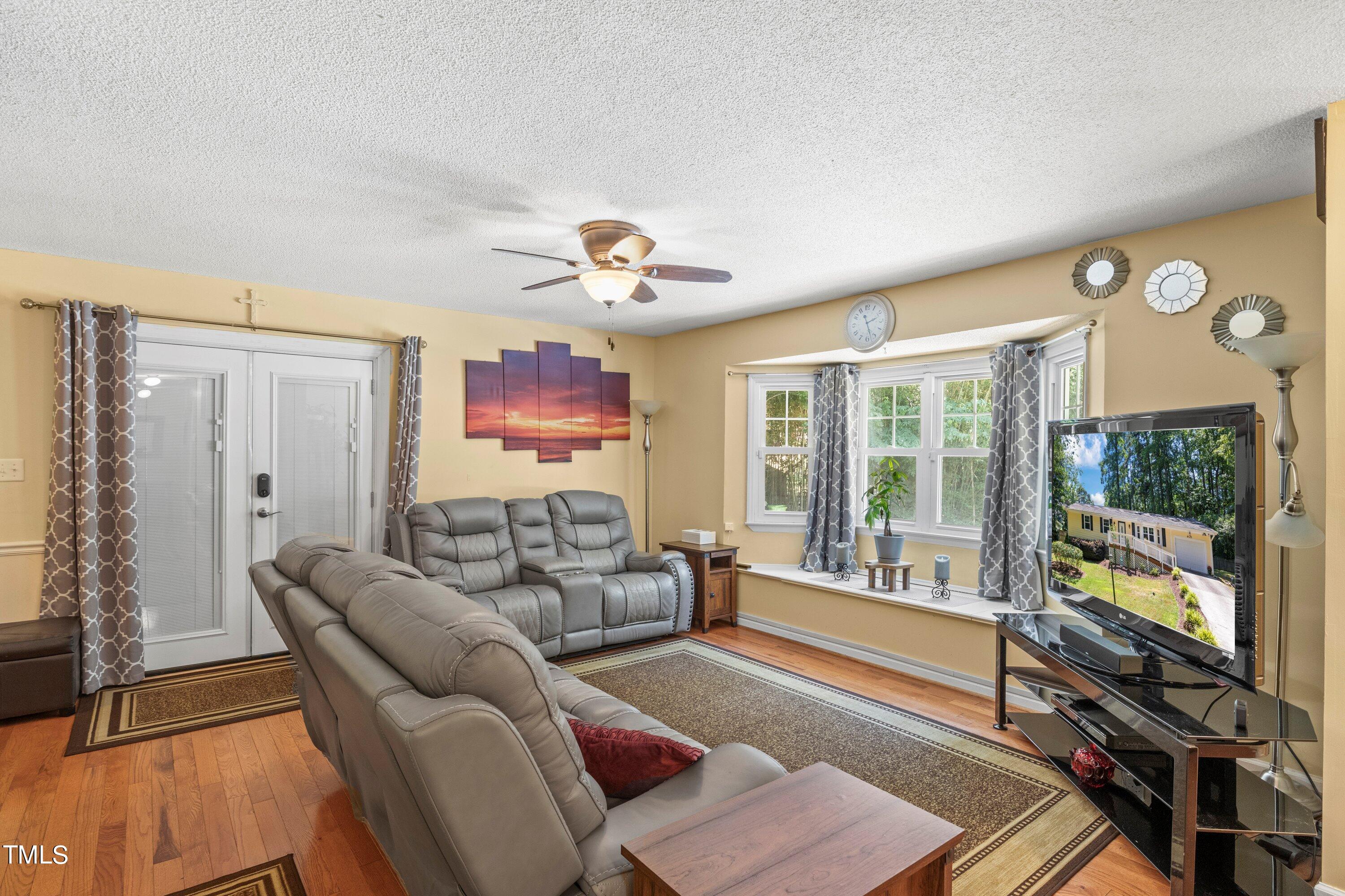 4125 Windsor Place Raleigh, NC 27609 - Photo 13 of 37 a living room with furniture and a flat screen tv