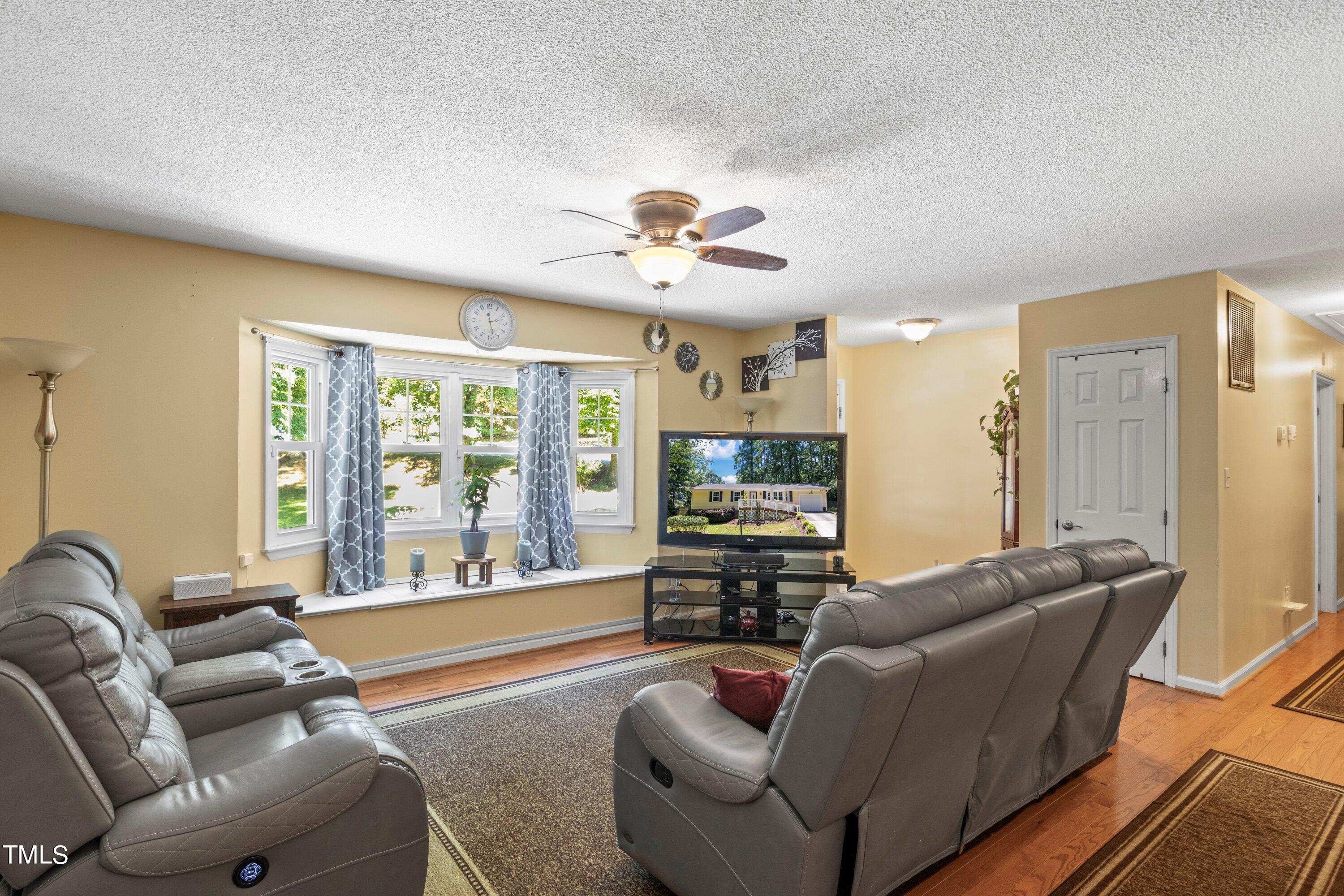 4125 Windsor Place Raleigh, NC 27609 - Photo 14 of 37 a living room with furniture and a large window