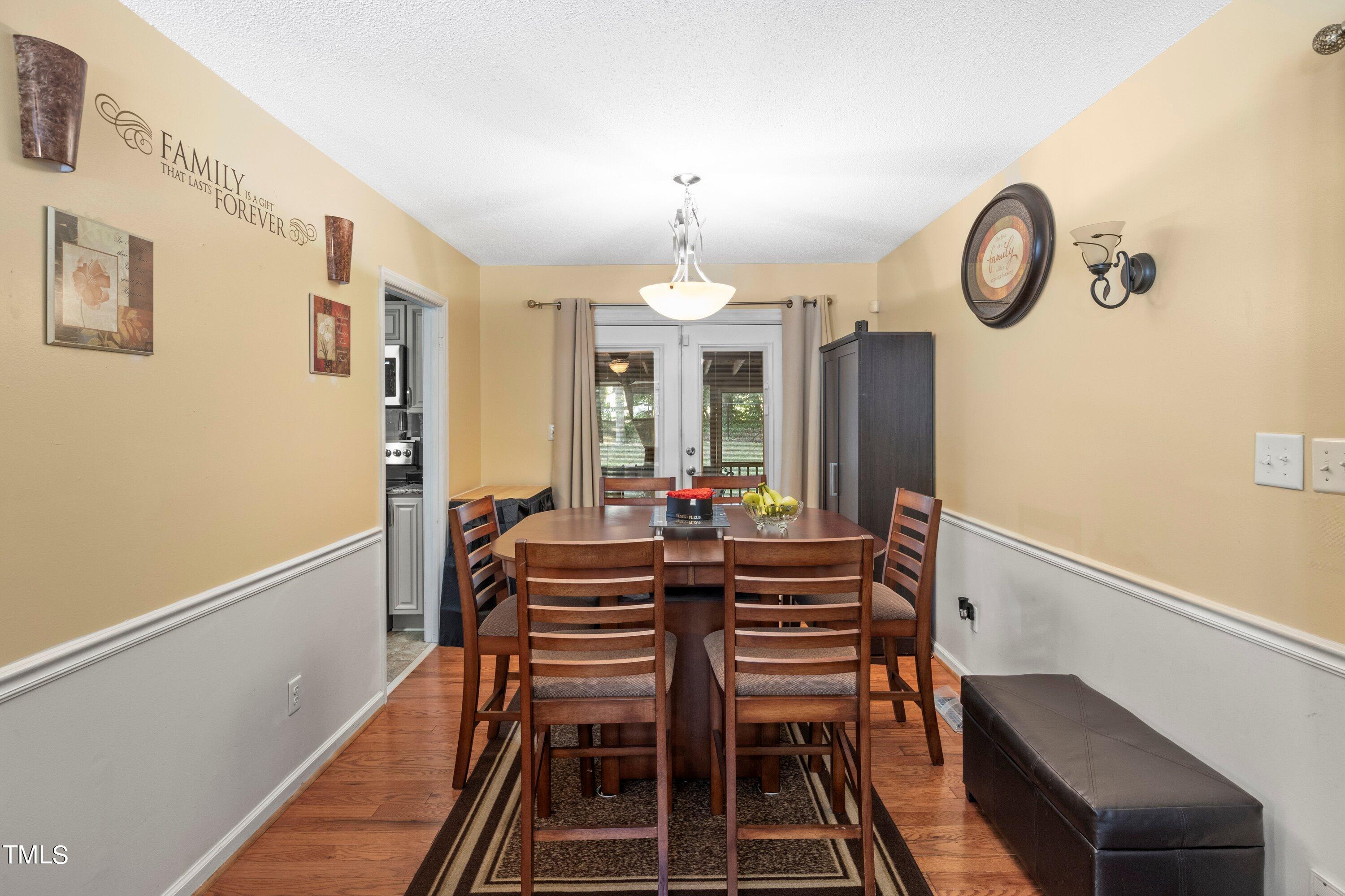4125 Windsor Place Raleigh, NC 27609 - Photo 22 of 37 a view of a dining room with furniture and chandelier