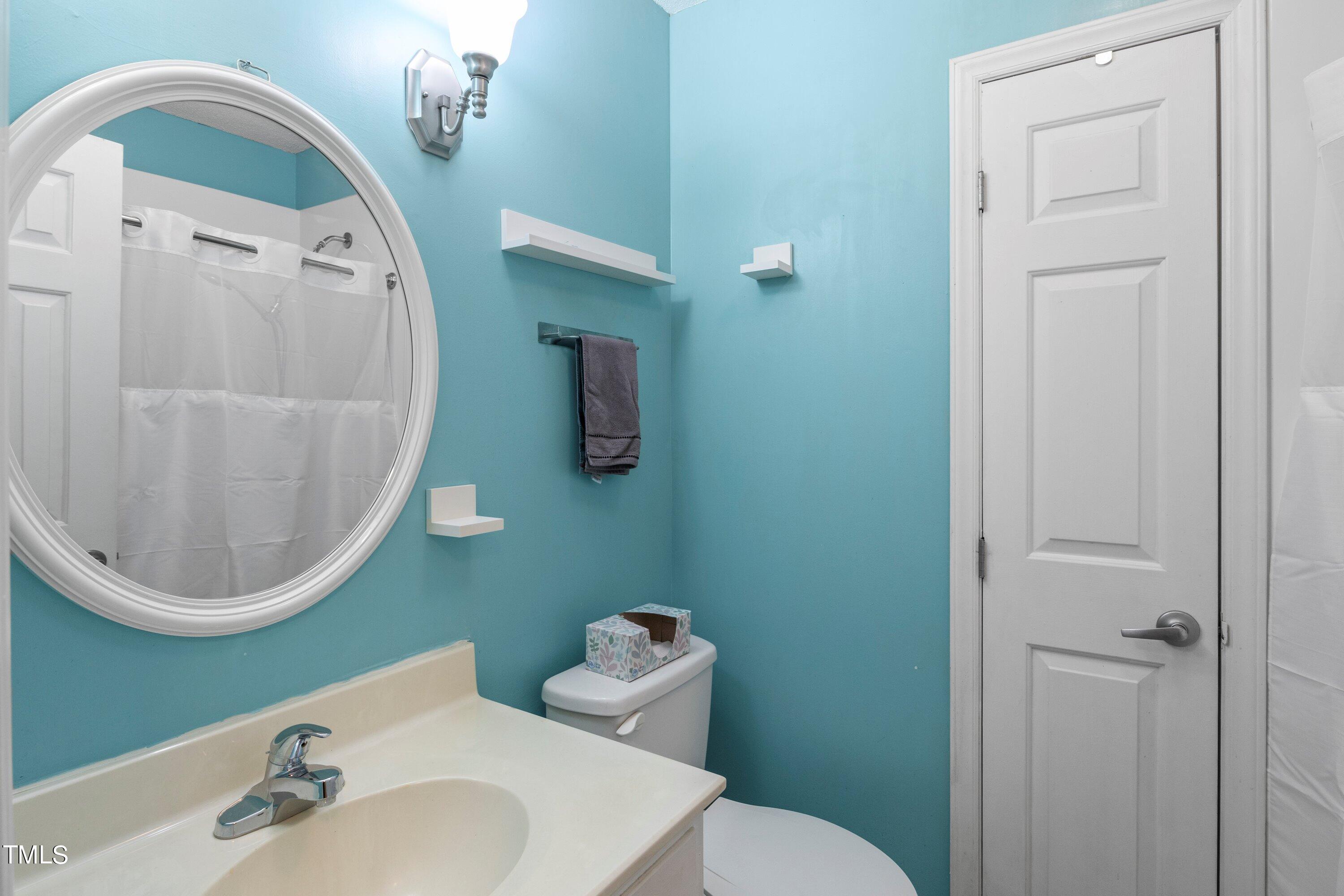 4125 Windsor Place Raleigh, NC 27609 - Photo 23 of 37 a bathroom with a sink mirror and toilet