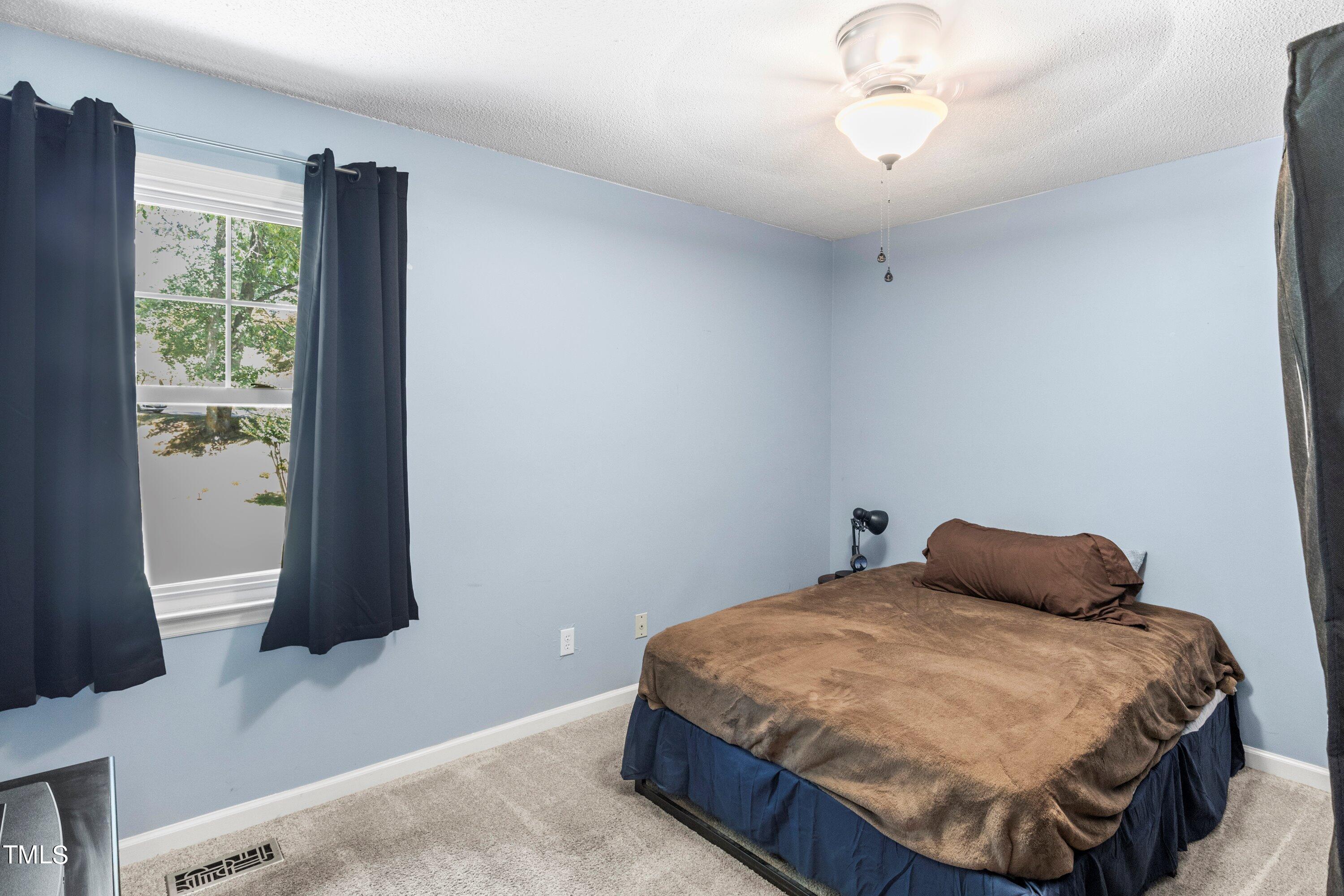 4125 Windsor Place Raleigh, NC 27609 - Photo 26 of 37 a bedroom with a bed and a window