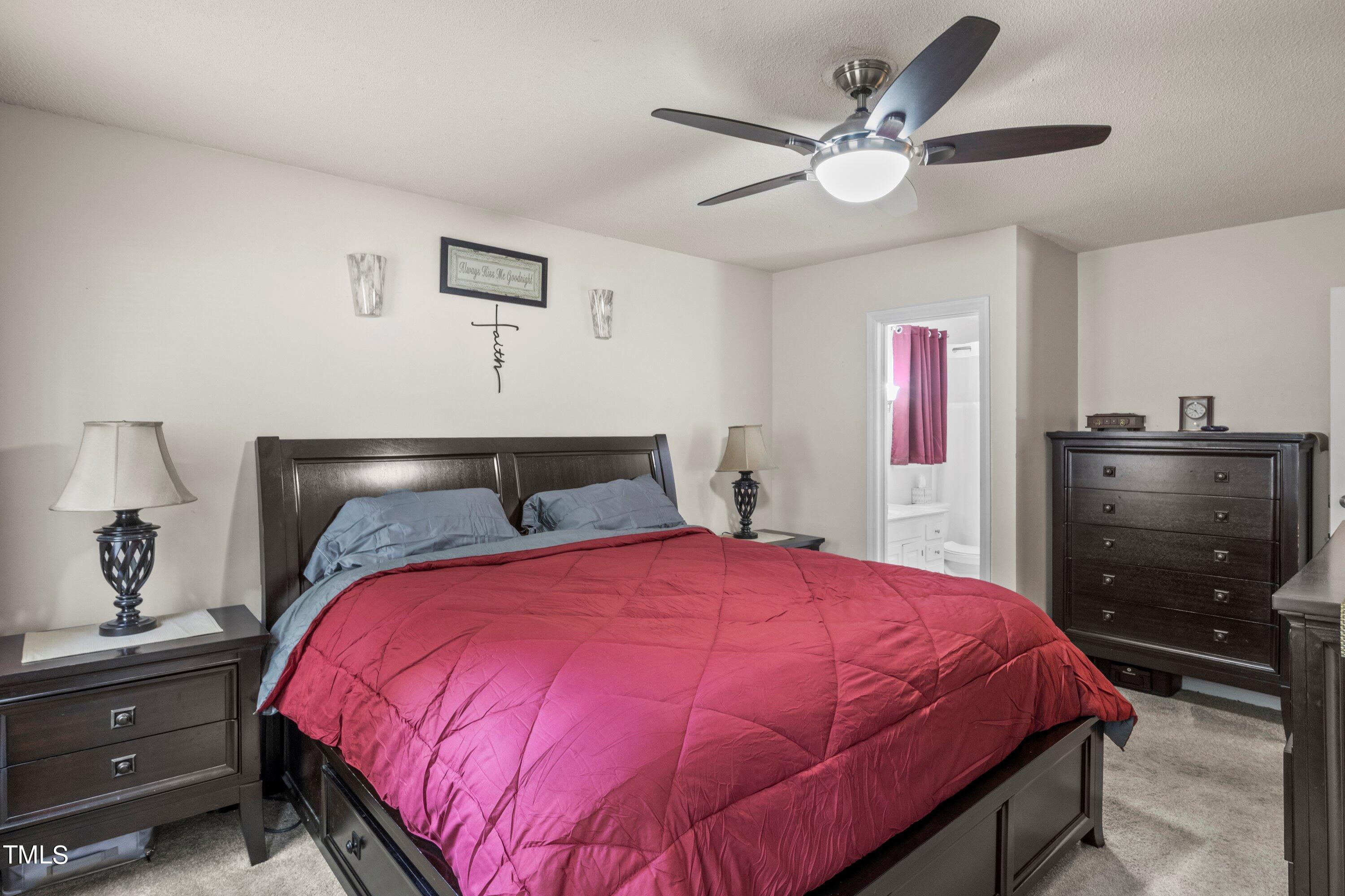 4125 Windsor Place Raleigh, NC 27609 - Photo 30 of 37 a bed sitting in a bedroom and a chandelier