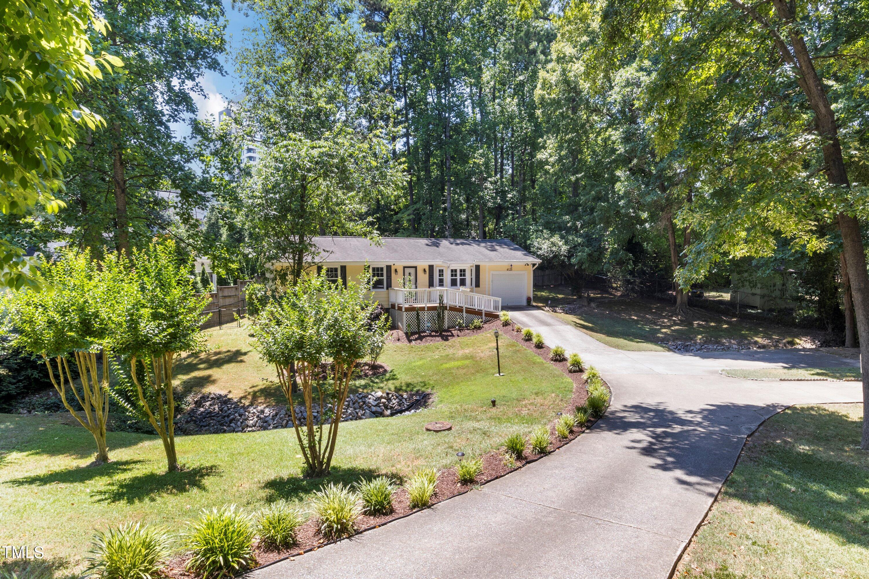 4125 Windsor Place Raleigh, NC 27609 - Photo 3 of 37 a view of a garden with a house