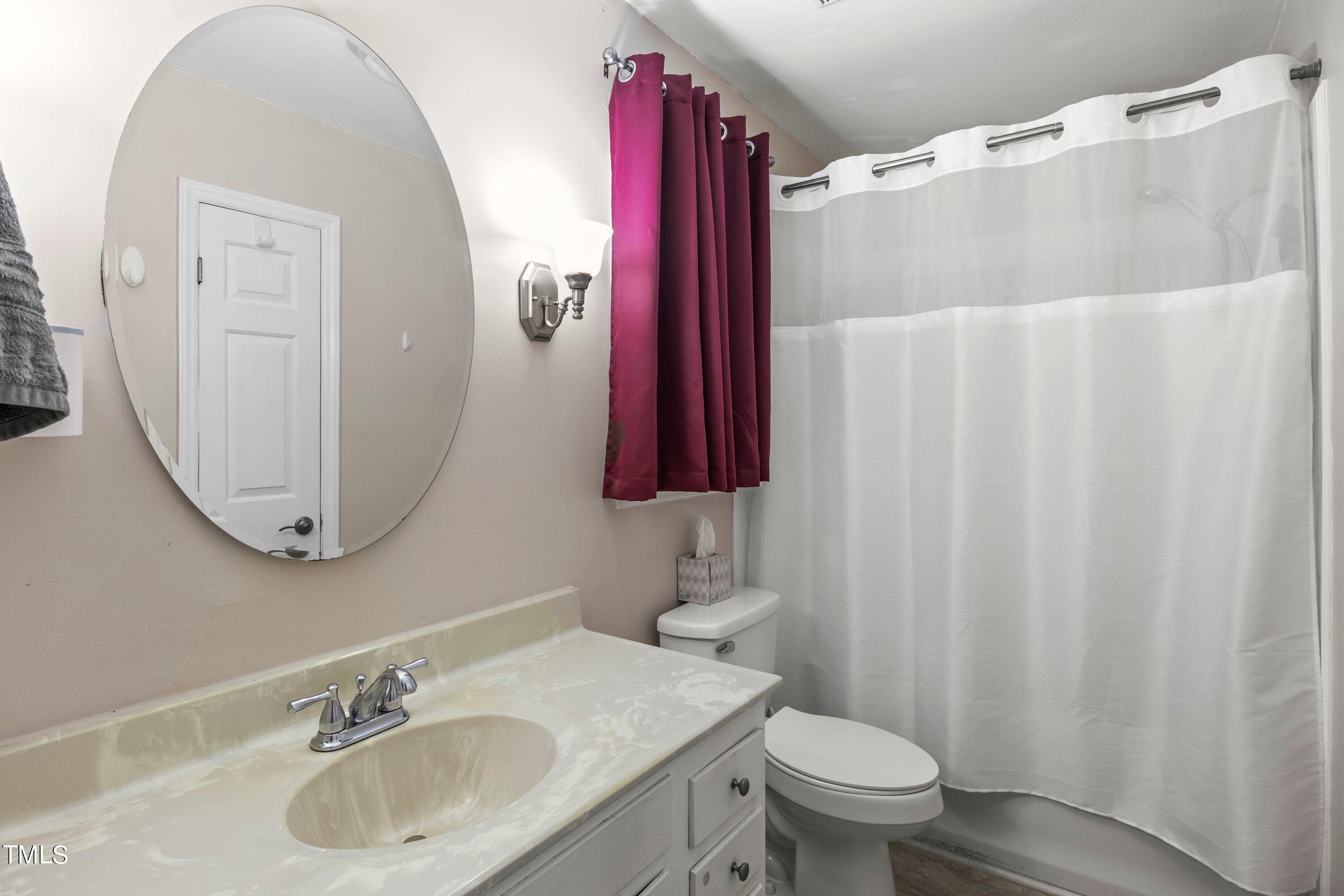 4125 Windsor Place Raleigh, NC 27609 - Photo 31 of 37 a bathroom with a sink toilet and mirror