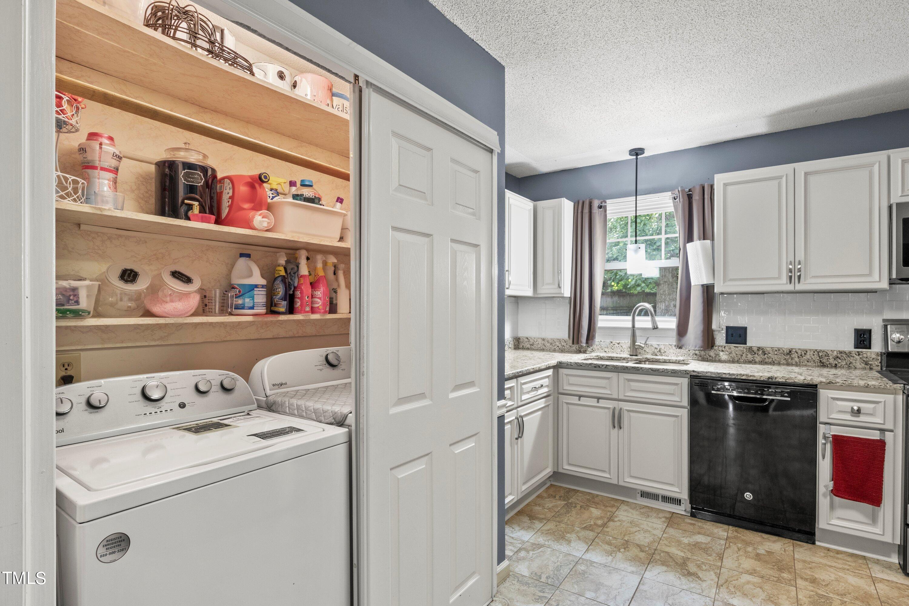 4125 Windsor Place Raleigh, NC 27609 - Photo 32 of 37 a view of cabinets a washer and dryer
