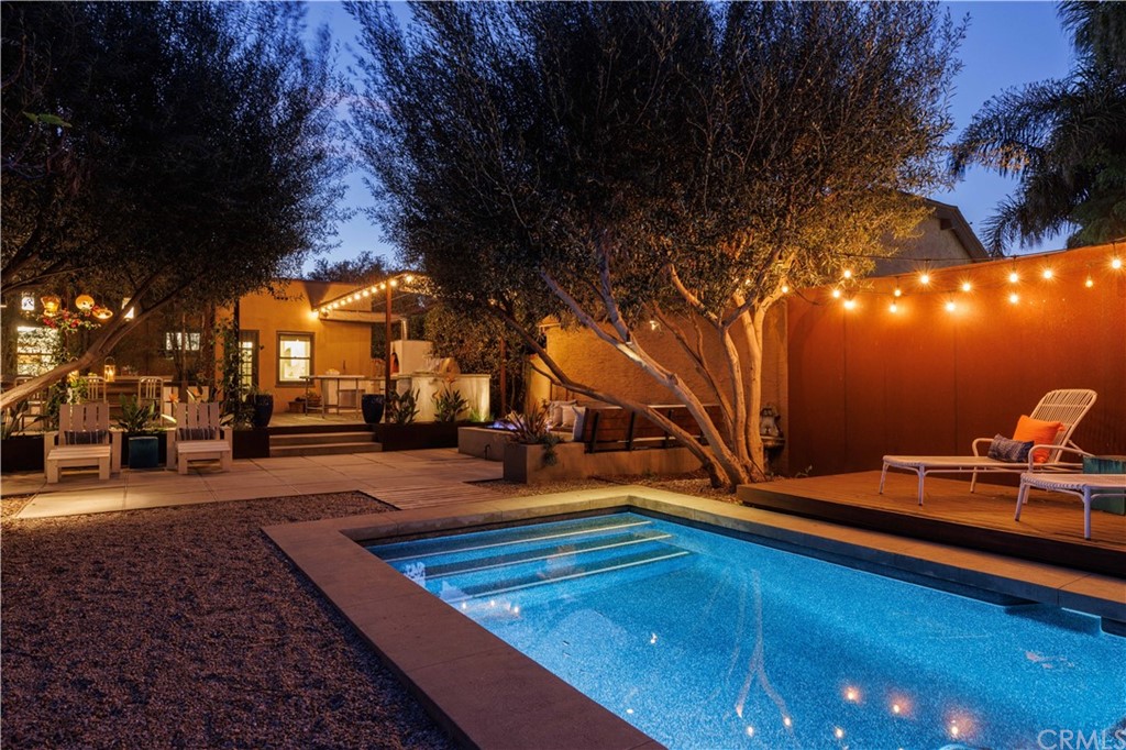a view of a house with backyard and sitting area