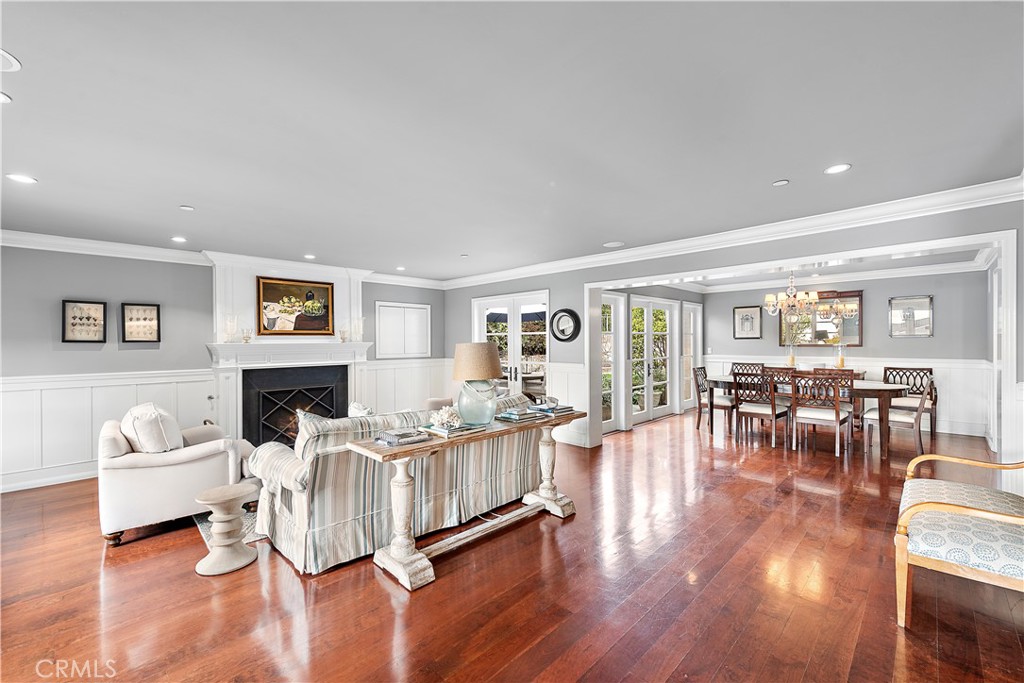 324 Emerald Bay Laguna Beach, CA 92651 - Photo 23 of 47 a living room with furniture a fireplace and a dining table with wooden floor