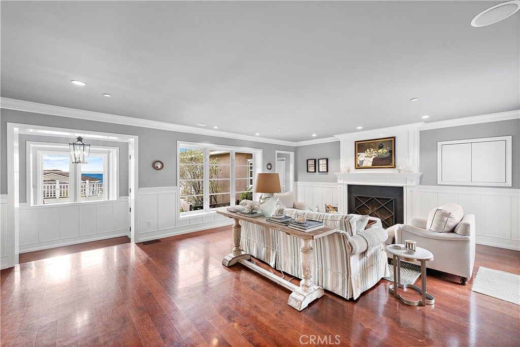 324 Emerald Bay Laguna Beach, CA 92651 - Photo 25 of 47 a living room with fireplace furniture and a wooden floor
