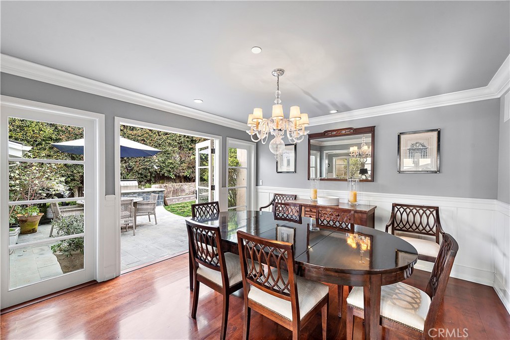 324 Emerald Bay Laguna Beach, CA 92651 - Photo 26 of 47 a view of a dining room with furniture a chandelier and wooden floor