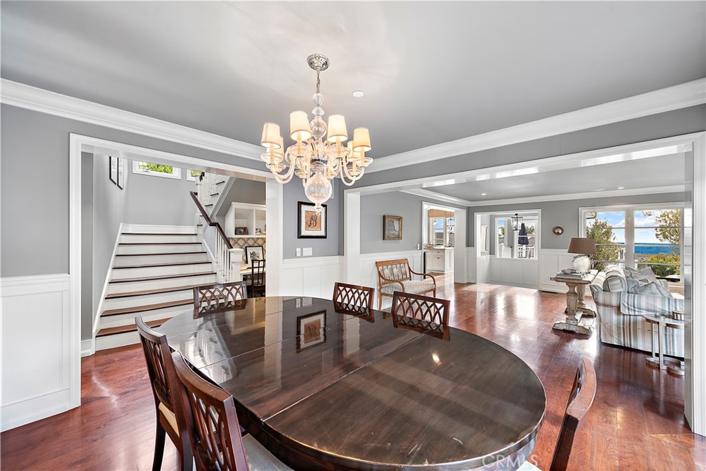 324 Emerald Bay Laguna Beach, CA 92651 - Photo 27 of 47 a dining room with wooden floor a chandelier a wooden table and chairs