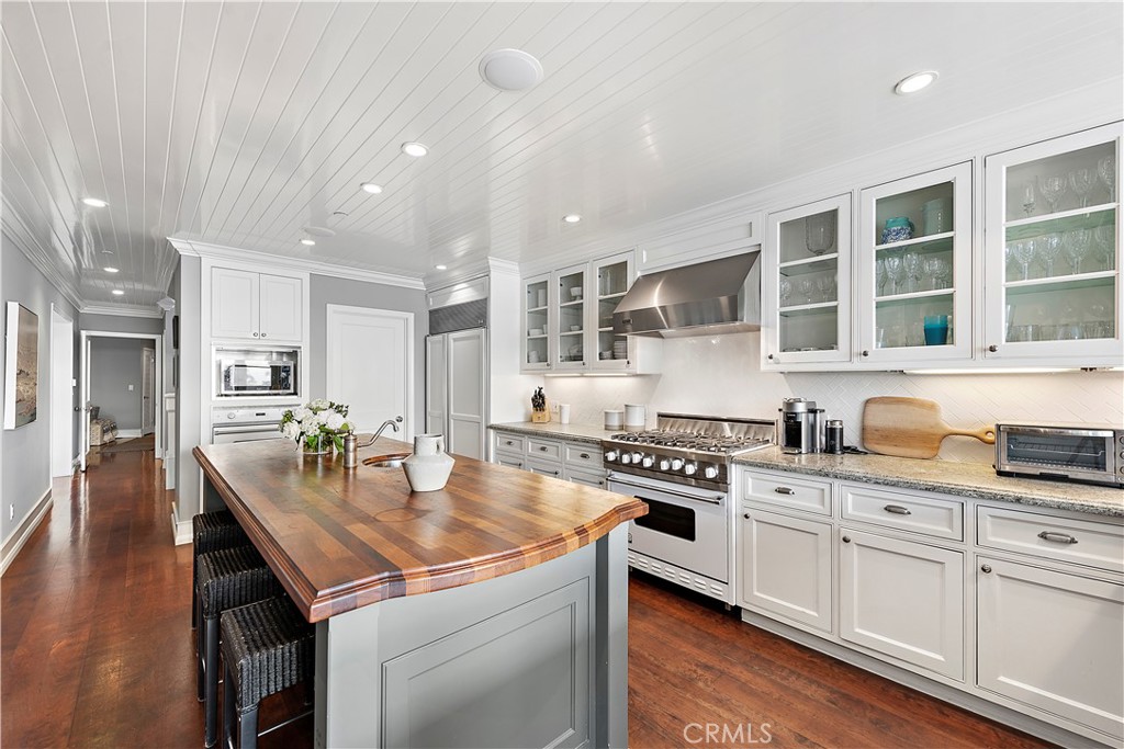 324 Emerald Bay Laguna Beach, CA 92651 - Photo 29 of 47 a kitchen with kitchen island granite countertop a sink and cabinets