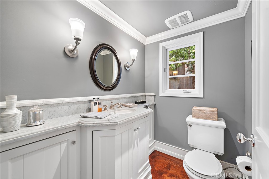 324 Emerald Bay Laguna Beach, CA 92651 - Photo 34 of 47 a bathroom with a toilet a sink a mirror and a window
