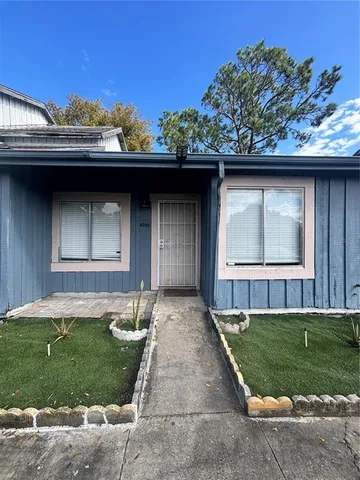 a backyard of a house with lots of green space and plants