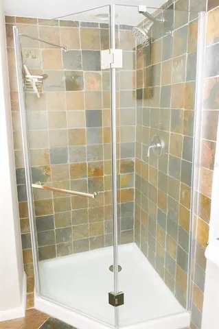 a bath tub sitting next to a shower