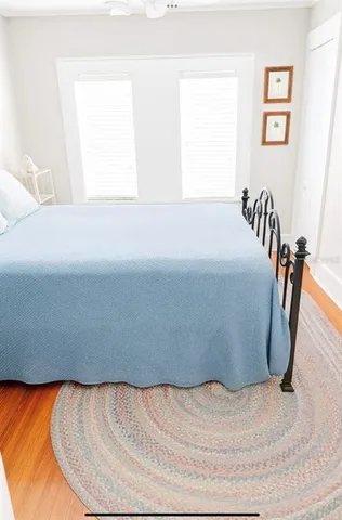 a bed sitting in a bedroom next to a window