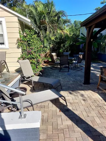 a view of a backyard with sitting area
