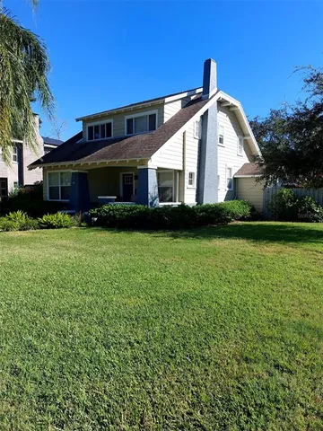 a view of house with yard and green space